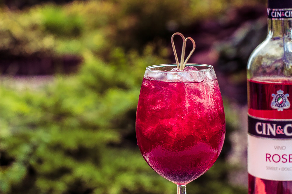 Orzeźwiający kobiecy drink z różowym winem i jagodami.